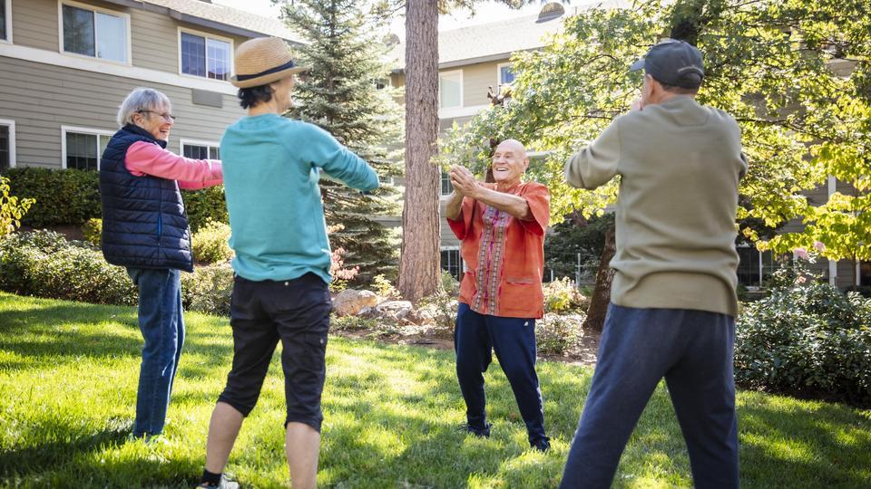 Residents practicing stretching outside